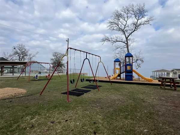 a view of outdoor space with playground and green space