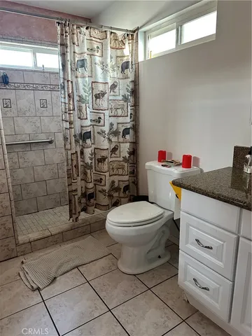 a bed sitting in a bedroom next to a lamp