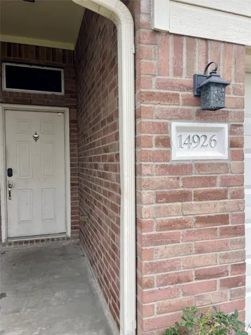 a view of a door and brick wall