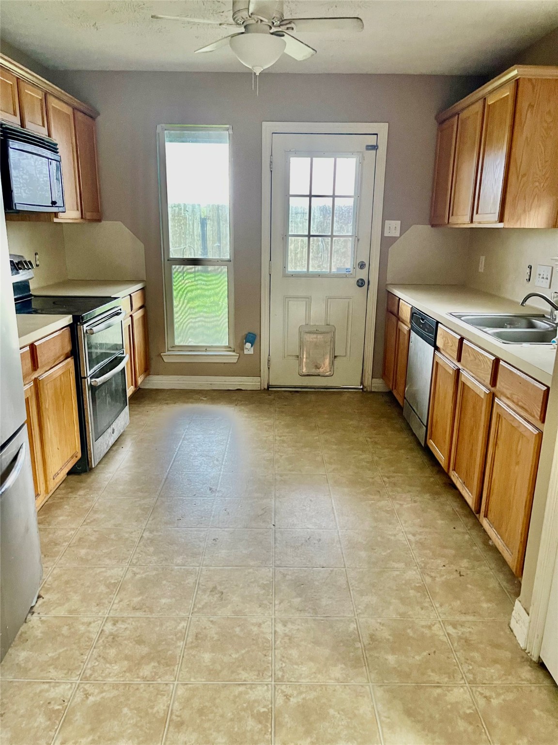 14926 Diamond Way Baytown, TX 77523 - Photo 6 of 12 a view of a kitchen with a sink stove cabinets and a window