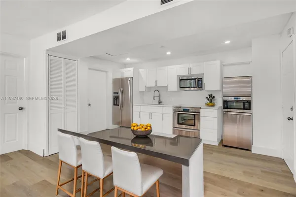 a kitchen with stainless steel appliances a refrigerator sink and stove