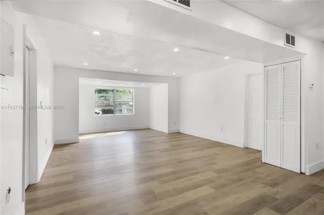 a view of an empty room and a window