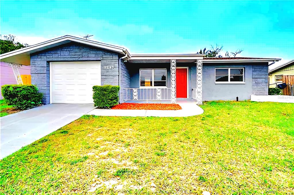 9643 Marlinton Lane Port Richey, FL 34668 - Photo 1 of 31 a front view of a house with a yard