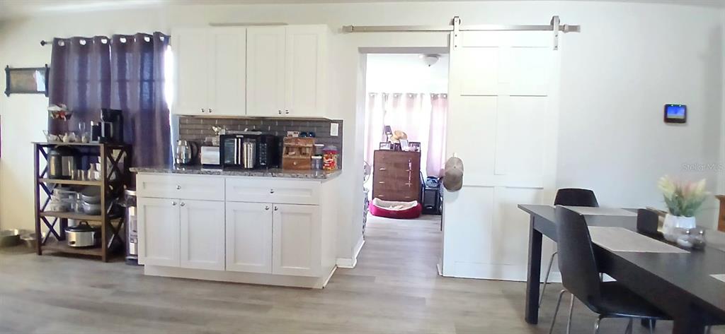 9643 Marlinton Lane Port Richey, FL 34668 - Photo 11 of 31 a view of a kitchen with furniture and wooden floor