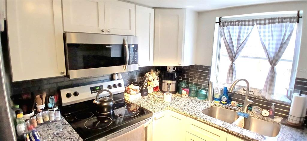 9643 Marlinton Lane Port Richey, FL 34668 - Photo 15 of 31 a kitchen with a stove and a sink