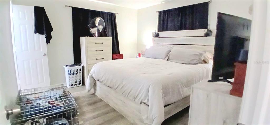 9643 Marlinton Lane Port Richey, FL 34668 - Photo 21 of 31 a bedroom with a bed and a refrigerator