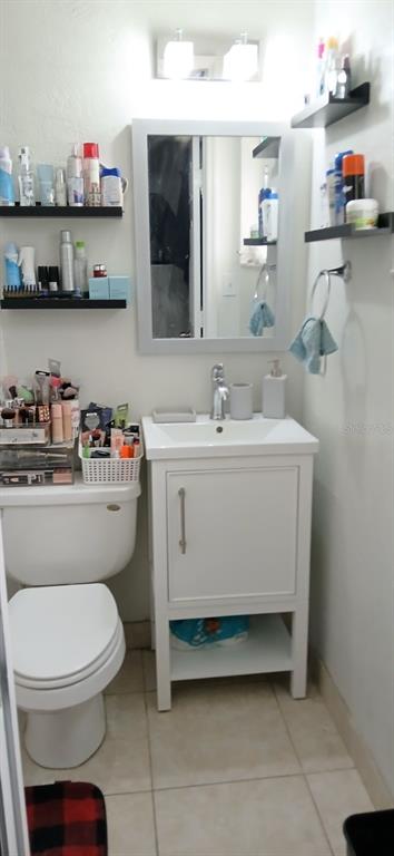 9643 Marlinton Lane Port Richey, FL 34668 - Photo 24 of 31 a bathroom with a toilet a sink and a mirror