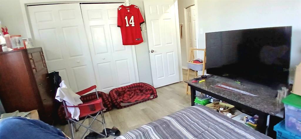 9643 Marlinton Lane Port Richey, FL 34668 - Photo 28 of 31 a bedroom with a bed and a flat screen tv