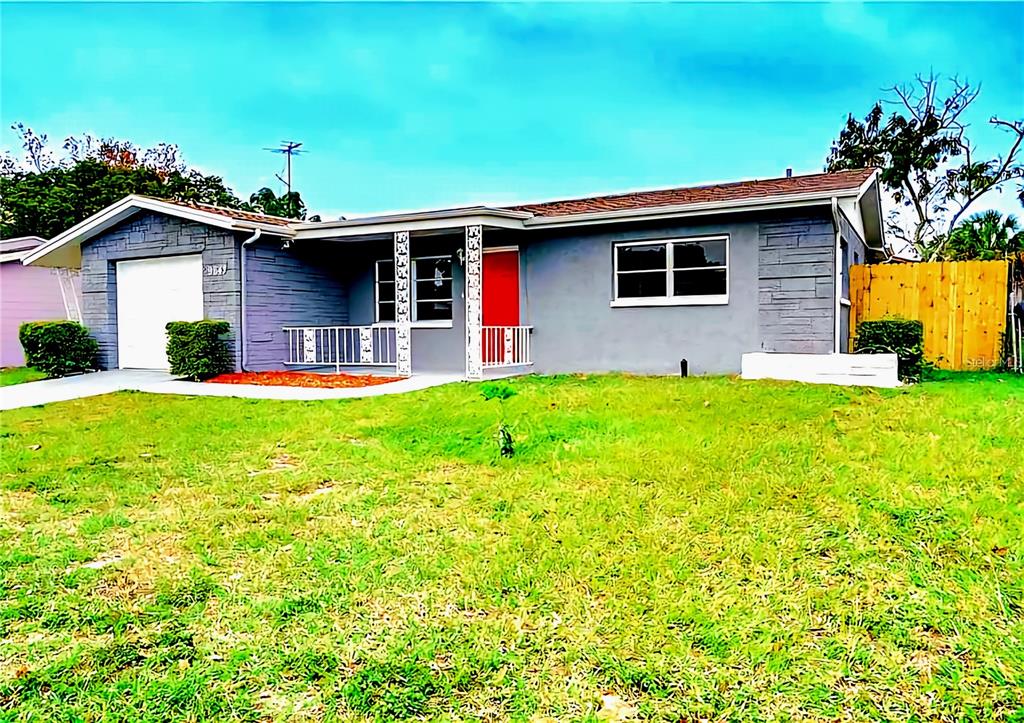 9643 Marlinton Lane Port Richey, FL 34668 - Photo 5 of 31 a front view of a house with a yard and garage