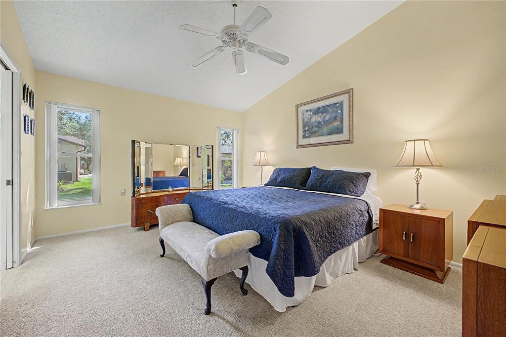 2662 Appleleaf Court Spring Hill, FL 34606 - Photo 15 of 47 a spacious bedroom with a bed a lamp and a large window