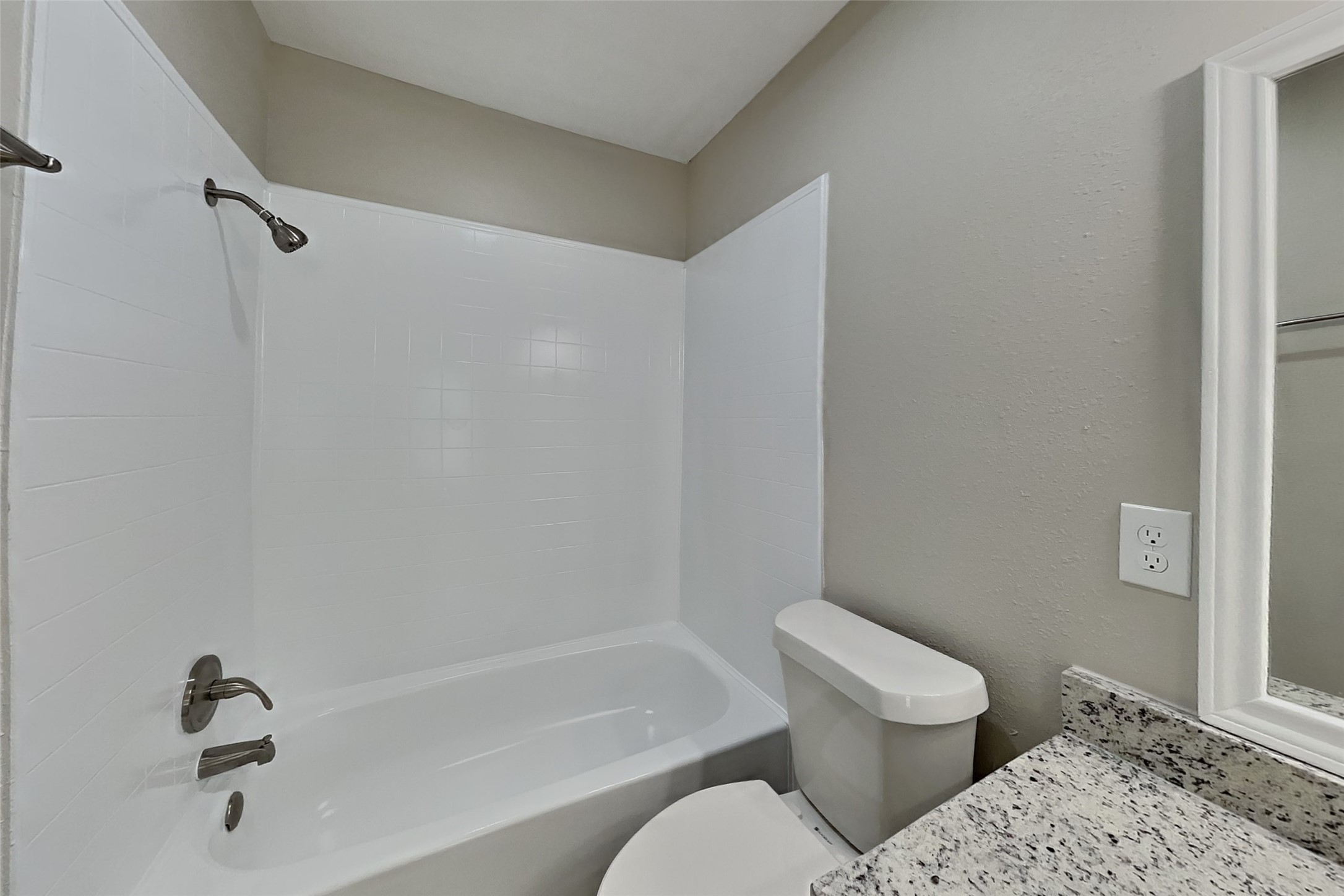 10015 Rippling Fields Drive Houston, TX 77064 - Photo 11 of 24 a bathroom with a toilet and a tub