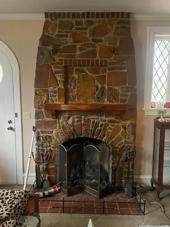 a close view of a fireplace with wooden door