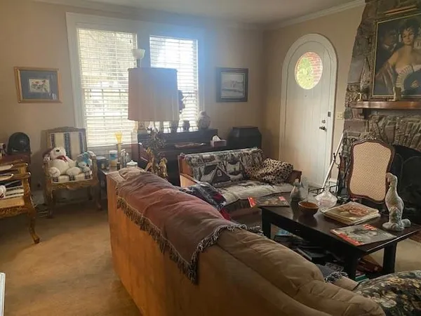 a living room with furniture a clock on walls and a window