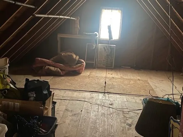 a view of a white house with large windows and a small yard