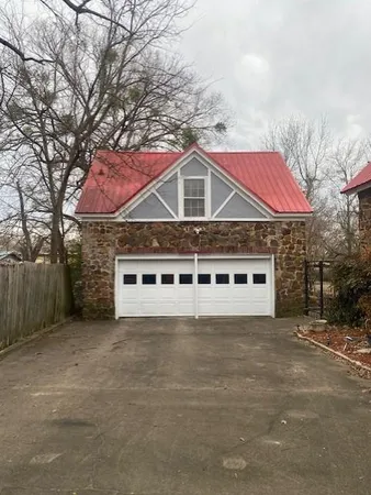 a view of a grey house with a yard