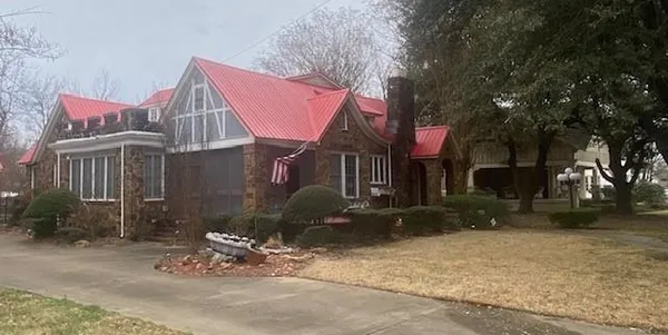 a view of front door and porch with wooden floor