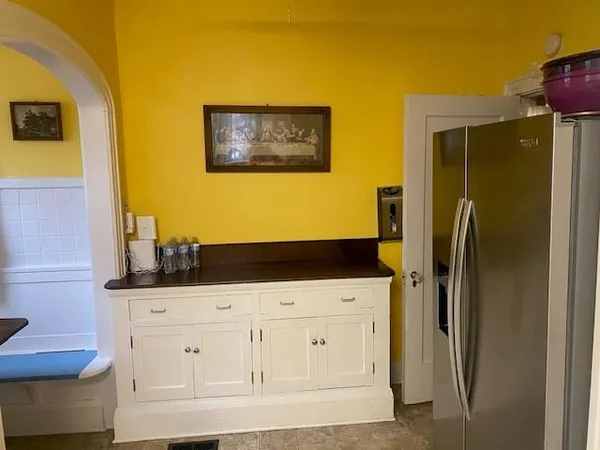 a kitchen with white cabinets and stainless steel appliances