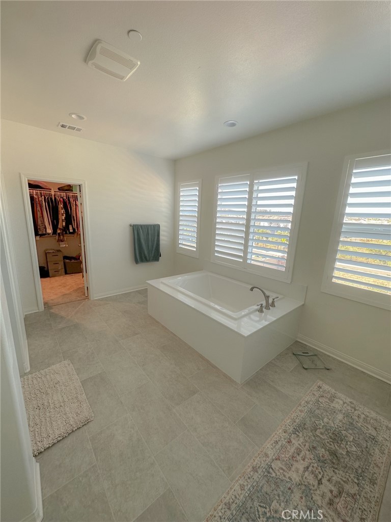 39547 Verbena Way Temecula, CA 92591 - Photo 12 of 31 a spacious bedroom with a bed and a couch
