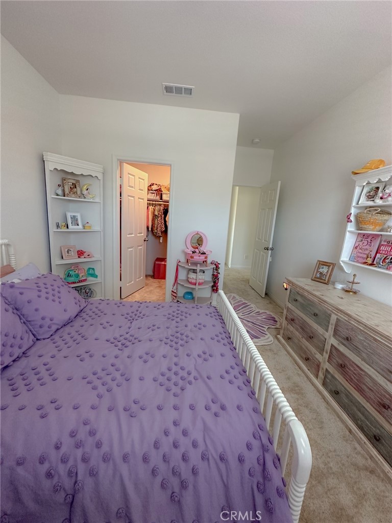 39547 Verbena Way Temecula, CA 92591 - Photo 17 of 31 a bedroom with a bed and dresser with mirror