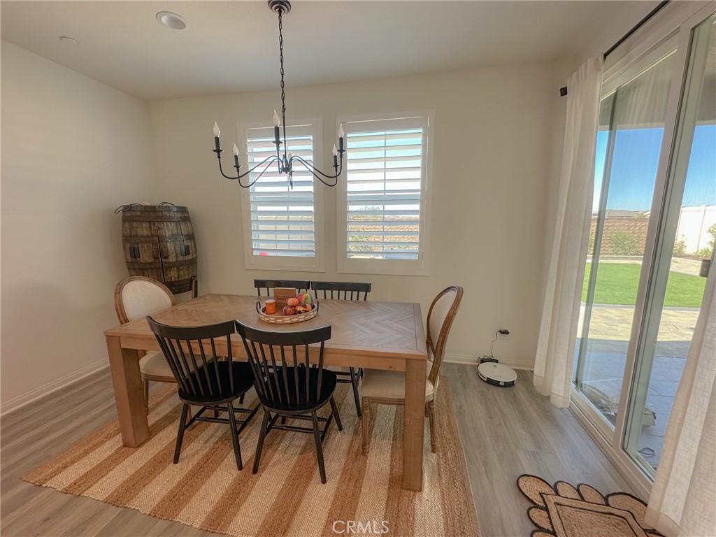 39547 Verbena Way Temecula, CA 92591 - Photo 5 of 31 a view of a dining room with furniture window and wooden floor