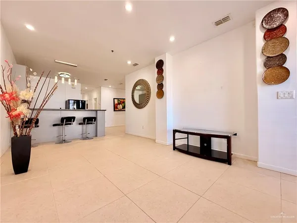 a kitchen with kitchen island granite countertop a sink appliances and cabinets