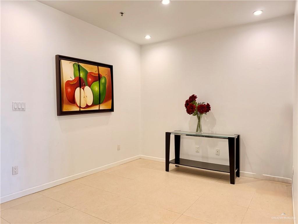 813 Travis Street, Unit 207 Mission, TX 78572 - Photo 17 of 38 a view of a hallway with paintings on the wall