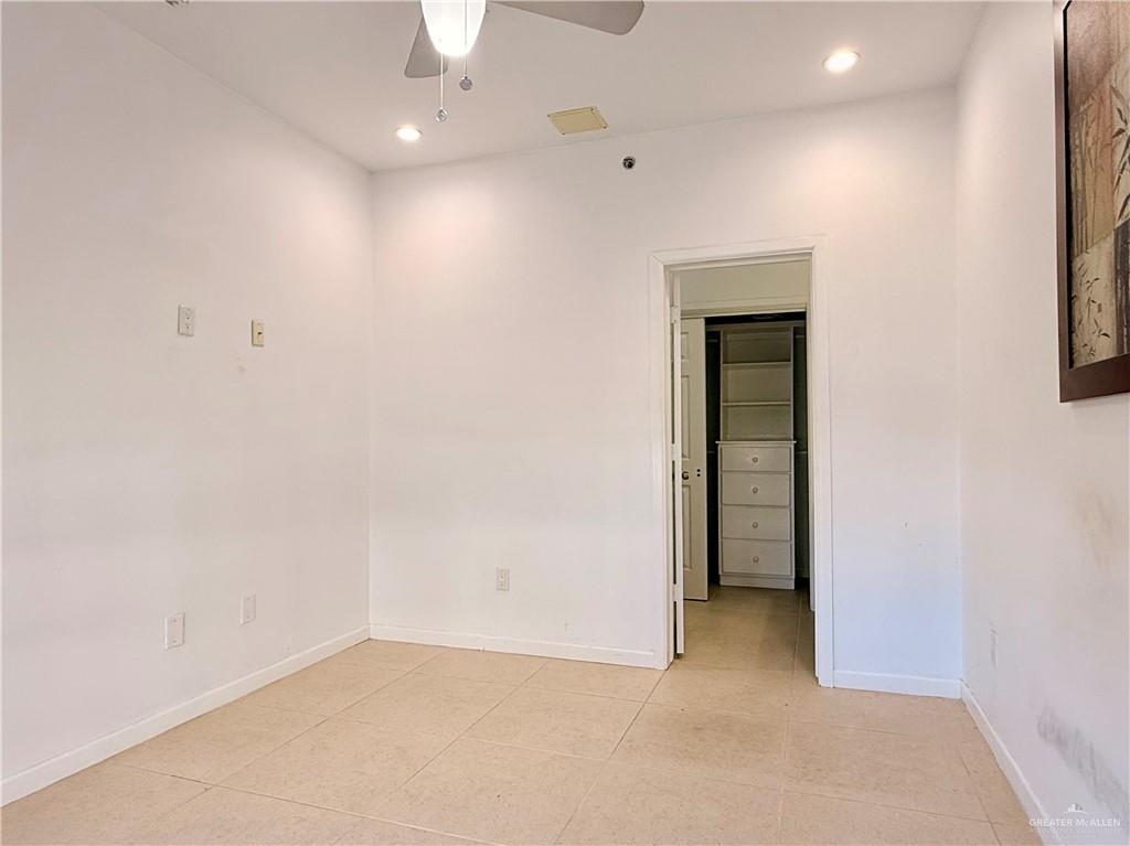 813 Travis Street, Unit 207 Mission, TX 78572 - Photo 18 of 38 an empty room with closet and a window