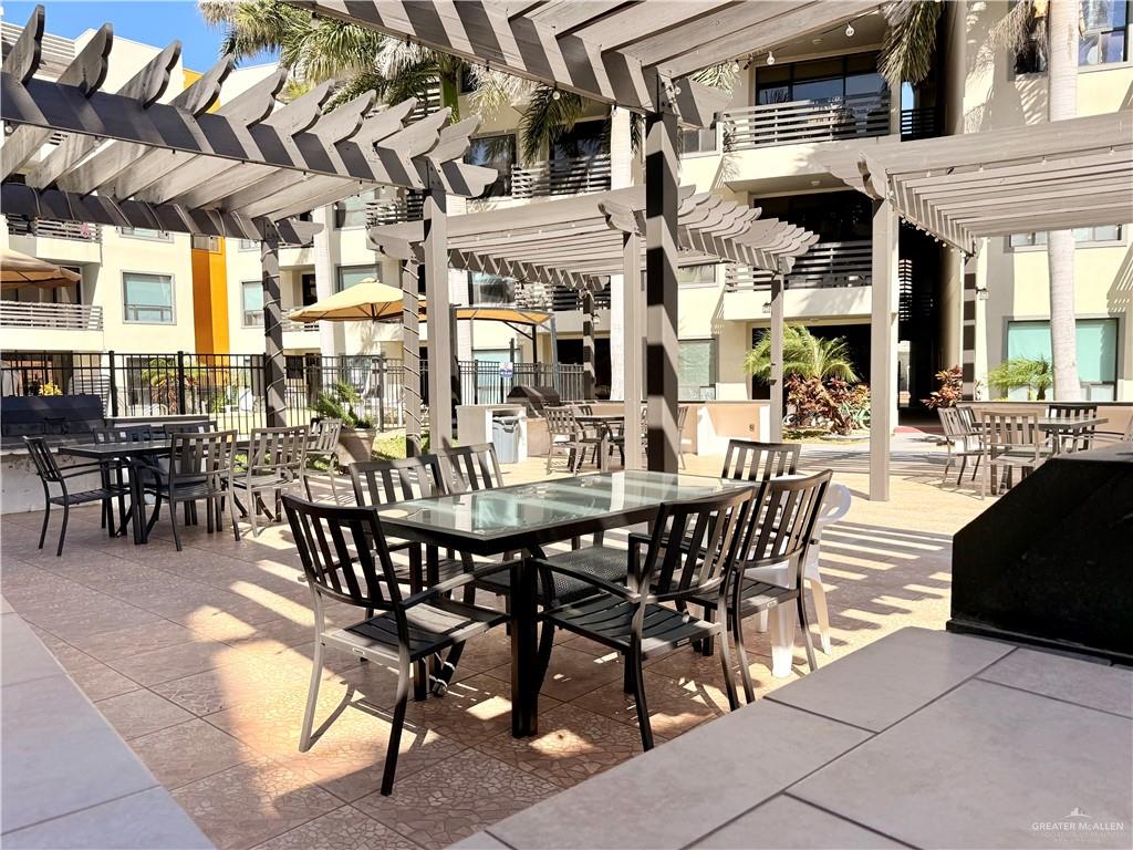 813 Travis Street, Unit 207 Mission, TX 78572 - Photo 29 of 38 a view of a dining table and chairs in the patio