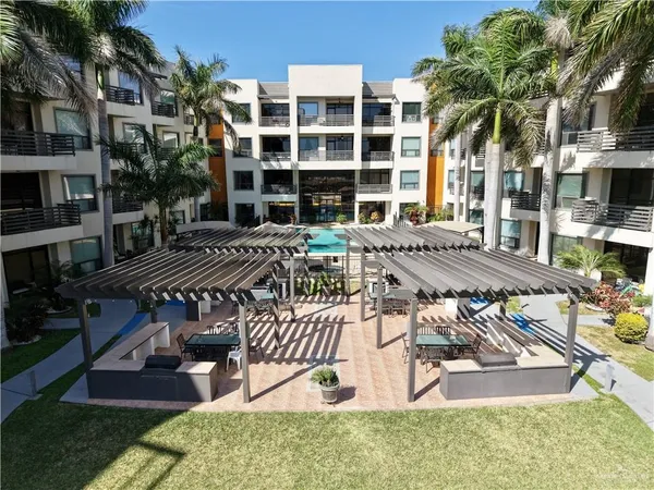 a view of a house with swimming pool and sitting area