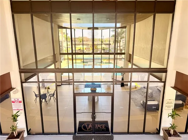 a view of a hallway with wooden floor and door