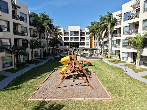 a view of a balcony with chairs potted plants