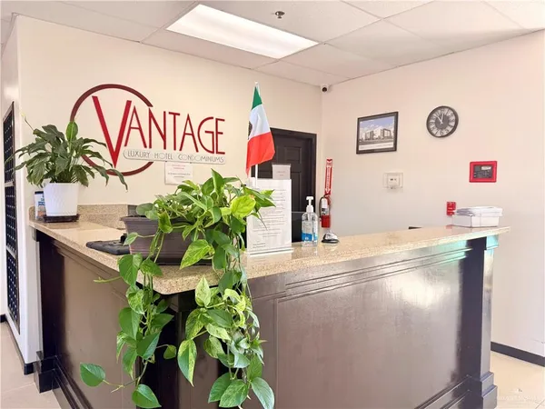 a dining room with furniture water view and a floor to ceiling window