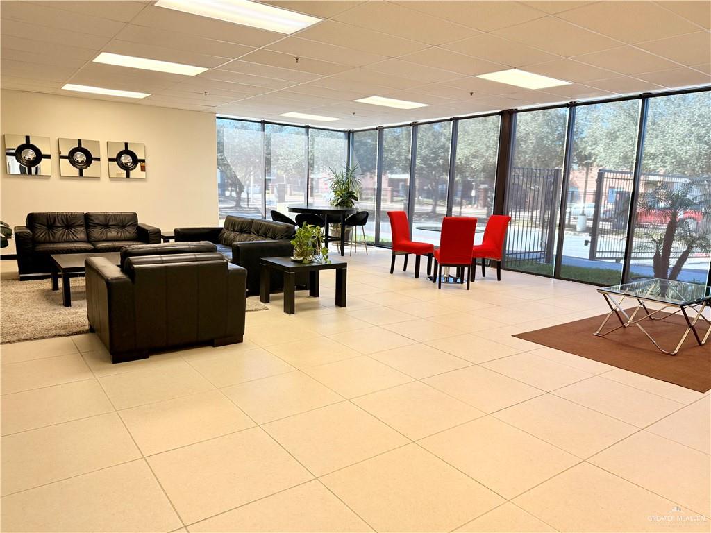 813 Travis Street, Unit 207 Mission, TX 78572 - Photo 8 of 38 a living room with furniture a rug and white walls