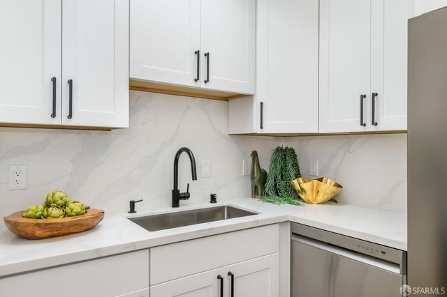 a kitchen with a sink a counter and cabinets