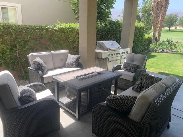 81225 Red Rock Road La Quinta, CA 92253 - Photo 7 of 13 a outdoor living space with furniture and garden view
