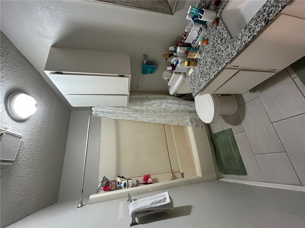 1500 Lemon Tree Lane College Station, TX 77840 - Photo 13 of 17 a bathroom with a granite countertop sink toilet and shower