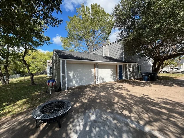 a view of a house with backyard and sitting area