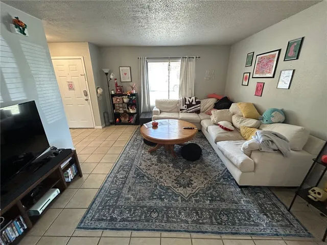 a living room with furniture and a rug