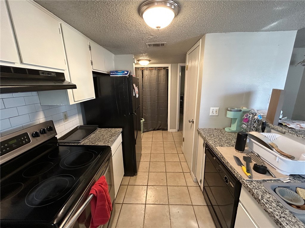 1500 Lemon Tree Lane College Station, TX 77840 - Photo 7 of 17 a kitchen with a stove and a refrigerator