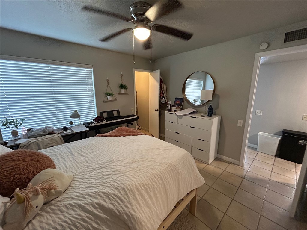 1500 Lemon Tree Lane College Station, TX 77840 - Photo 9 of 17 a bedroom with a bed and a chandelier