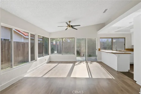 a living room with a large window with wooden floor