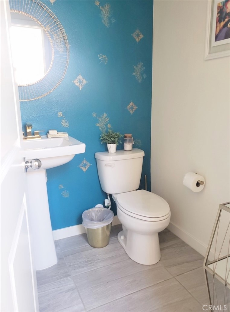 4120 Mission Tree Way Oceanside, CA 92057 - Photo 18 of 56 a bathroom with a toilet sink and mirror