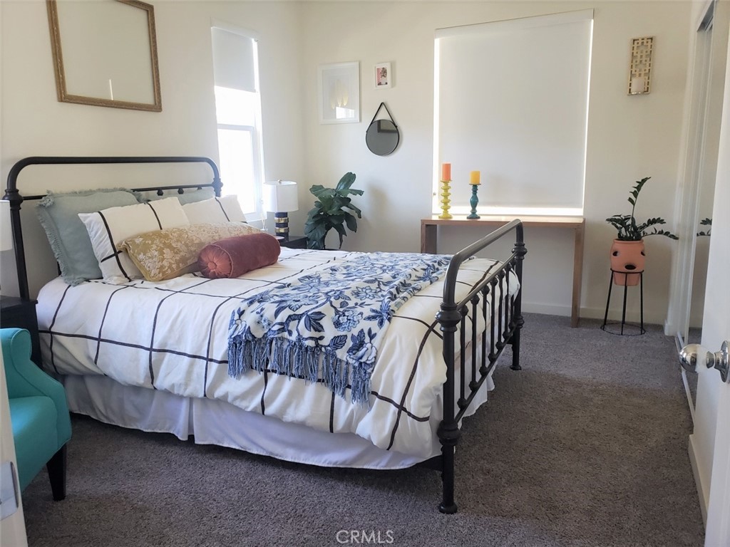 4120 Mission Tree Way Oceanside, CA 92057 - Photo 28 of 56 a bedroom with a bed and a table