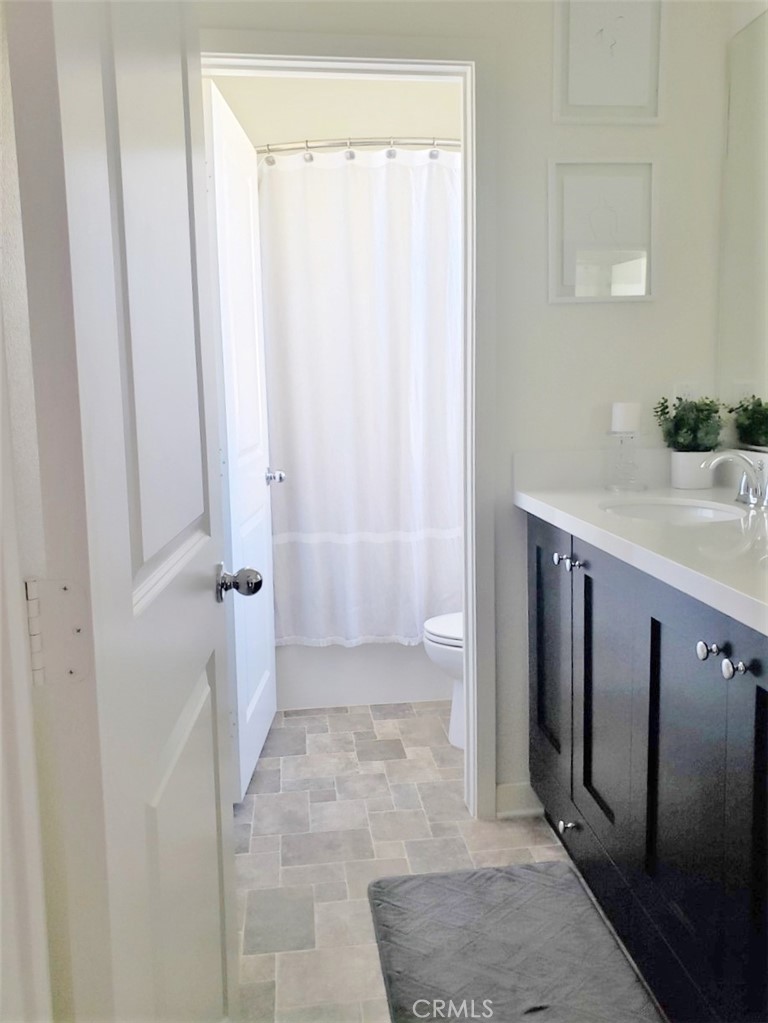 4120 Mission Tree Way Oceanside, CA 92057 - Photo 31 of 56 a bathroom with a granite countertop sink and a mirror