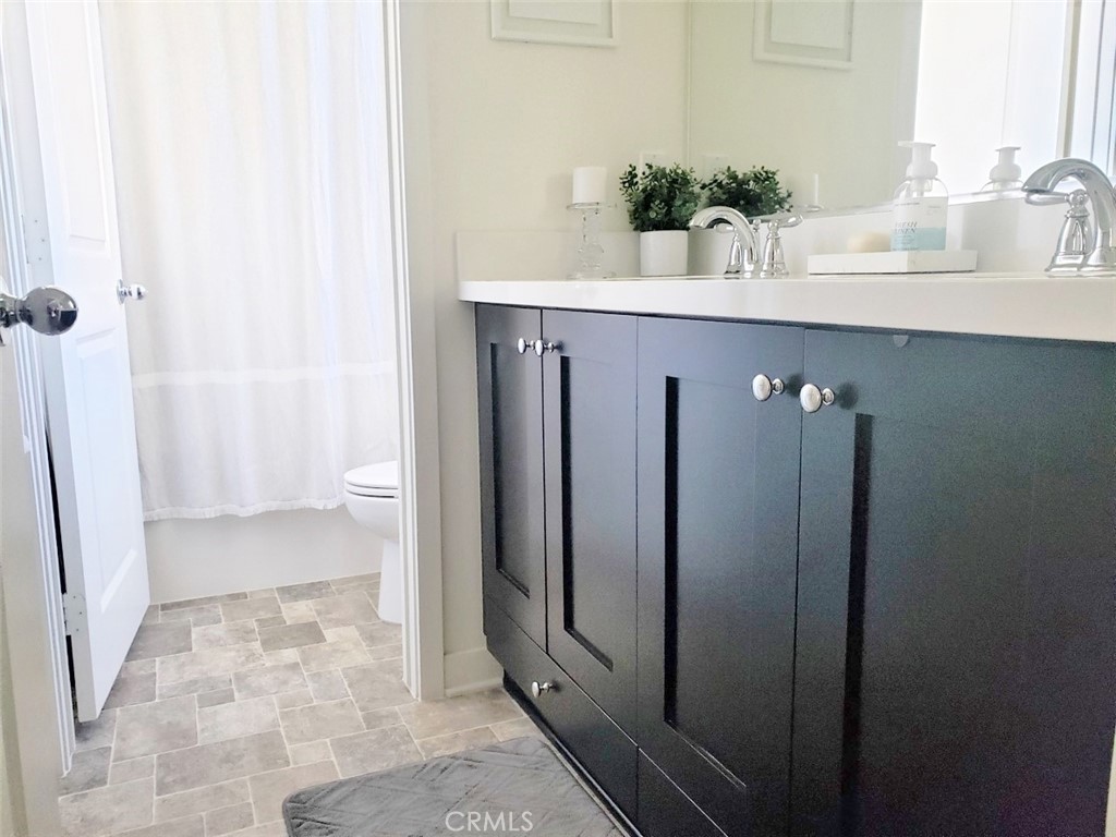 4120 Mission Tree Way Oceanside, CA 92057 - Photo 32 of 56 a bathroom with a sink a toilet and shower