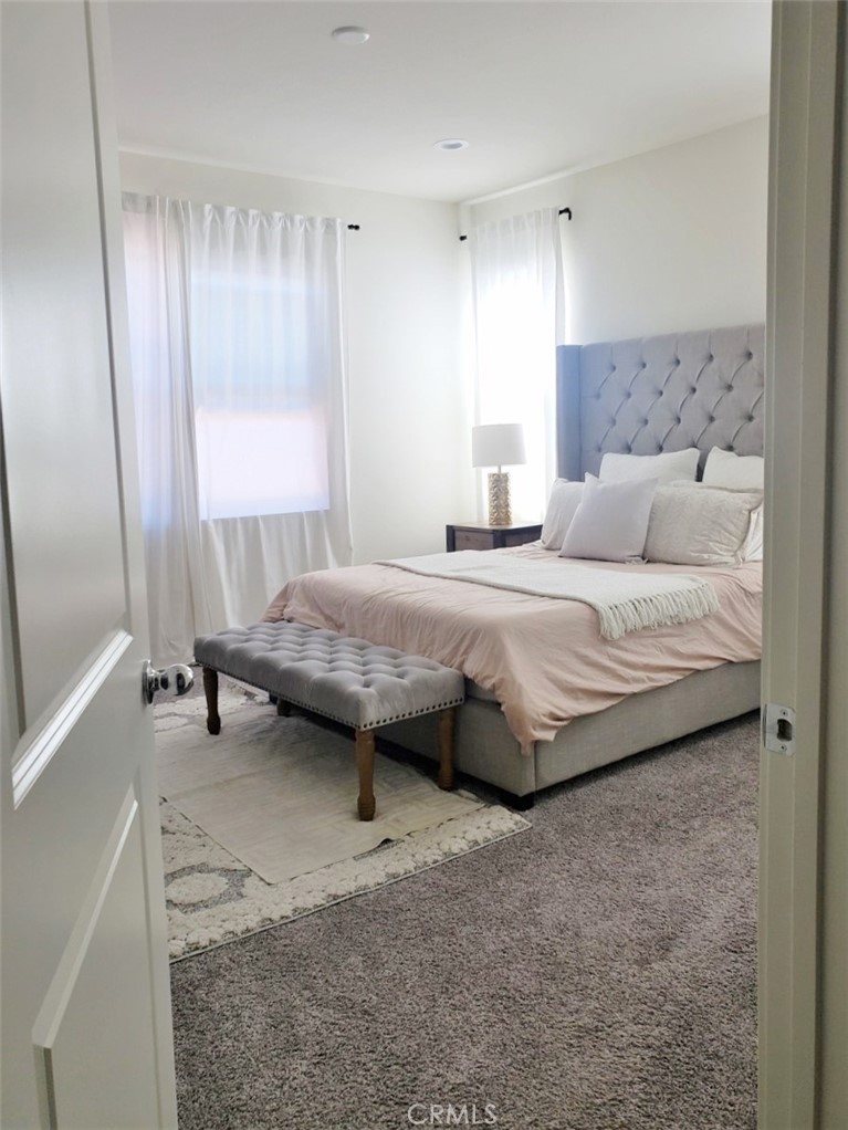 4120 Mission Tree Way Oceanside, CA 92057 - Photo 38 of 56 a bedroom with a bed and a window