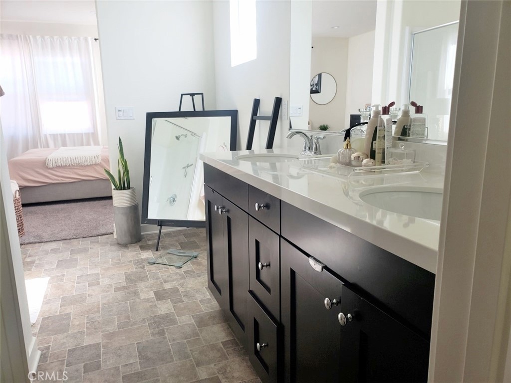 4120 Mission Tree Way Oceanside, CA 92057 - Photo 42 of 56 a bathroom with a double vanity sink and a mirror
