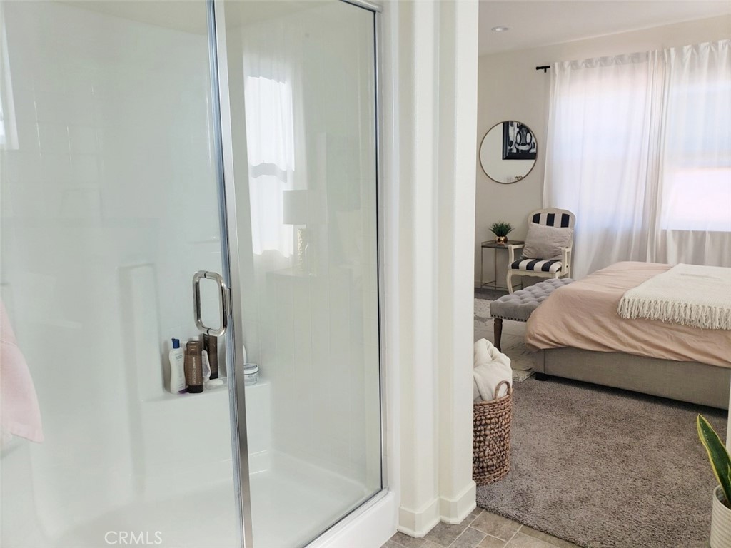 4120 Mission Tree Way Oceanside, CA 92057 - Photo 43 of 56 a bedroom with a bed and a chandelier