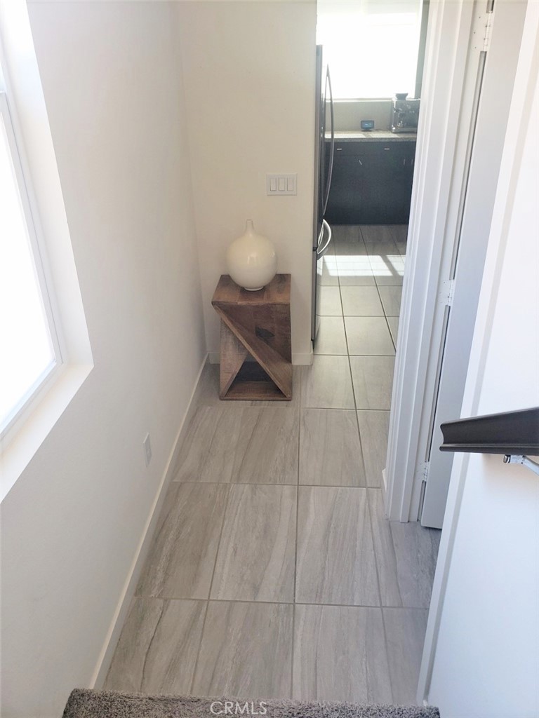 4120 Mission Tree Way Oceanside, CA 92057 - Photo 46 of 56 a hallway with table and a rug