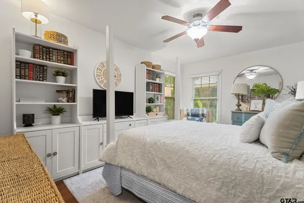 a bedroom with furniture and wooden floor